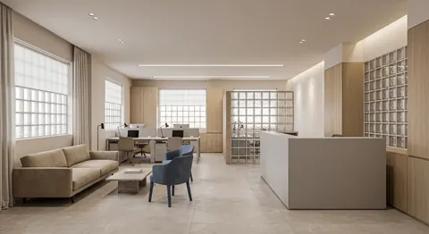 تصميم استقبال كاونتر أبيض بجدار طوب زجاجي